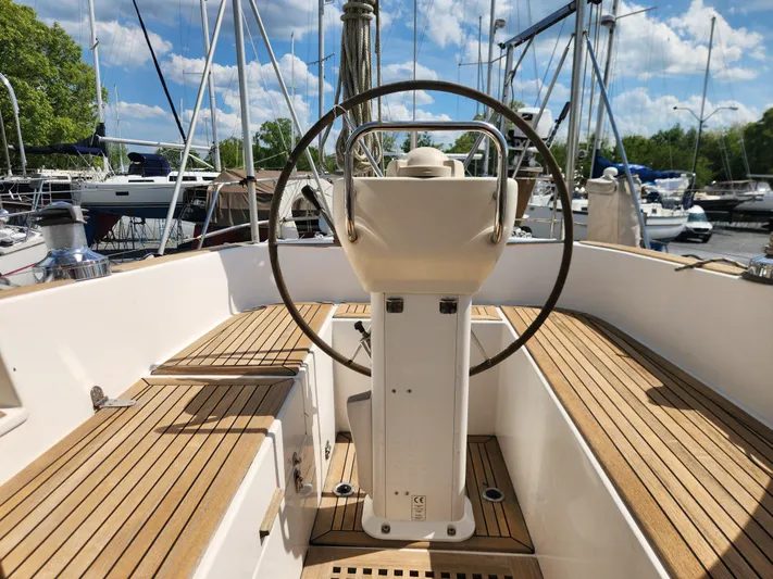 Vivace 1 Yacht Photos Pics Cockpit of 2002 Hallberg-Rassy 36 MKII sailboat with wooden deck and steering wheel.