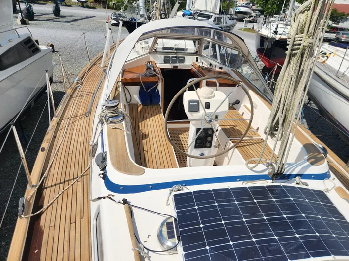 Vivace 1 Yacht Photos Pics Hallberg-Rassy 36 MKII 2002 sailboat with teak deck and solar panel, docked in a marina.