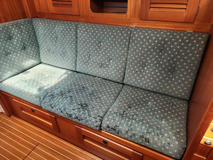 Vivace 1 Yacht Photos Pics Worn green sofa in 2002 Hallberg-Rassy 36 MKII yacht interior.