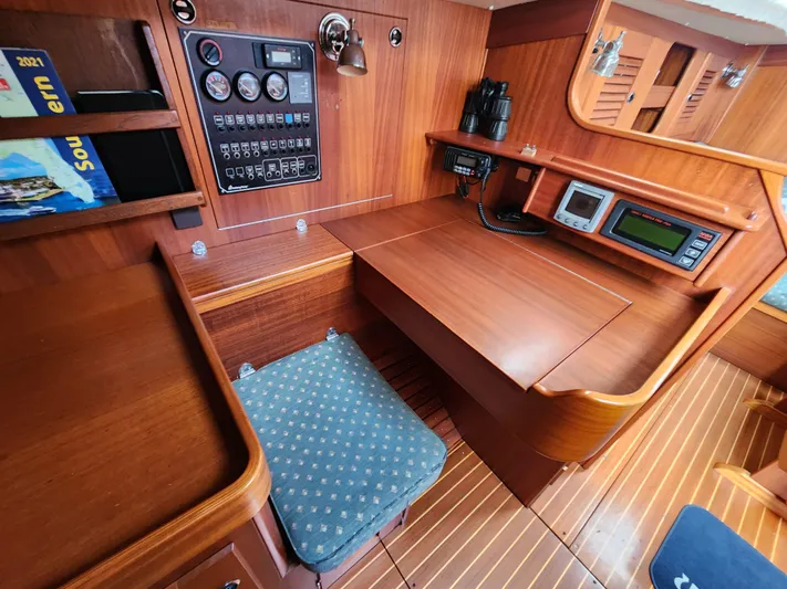 Vivace 1 Yacht Photos Pics Hallberg-Rassy 36 MKII 2002 yacht interior with navigation station and wooden cabinetry.