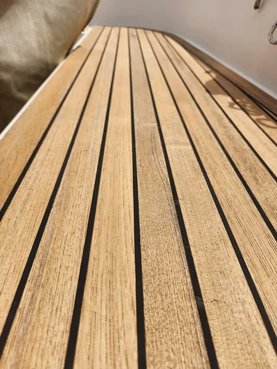 Vivace 1 Yacht Photos Pics Teak deck of 2002 Hallberg-Rassy 36 MKII sailboat, showcasing elegant wood finish.