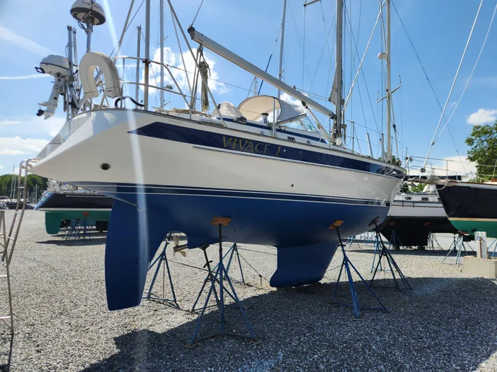 Vivace 1 Yacht Photos Pics 2002 Hallberg-Rassy 36 MKII sailboat on stands, blue and white hull, sunny day.