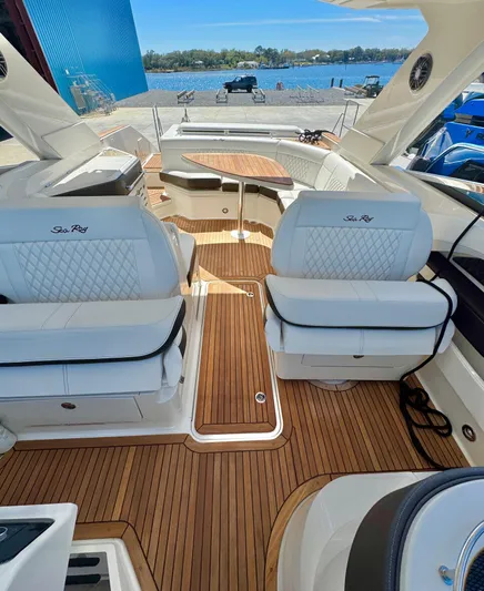  Yacht Photos Pics 2019 Sea Ray SLX 310 boat interior with luxurious seating and wooden flooring.