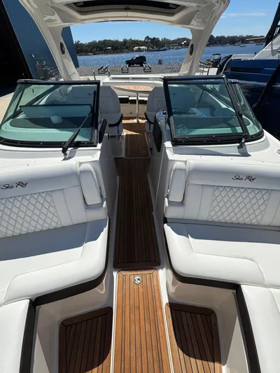  Yacht Photos Pics 2019 Sea Ray SLX 310 boat interior with white seating and wooden flooring.