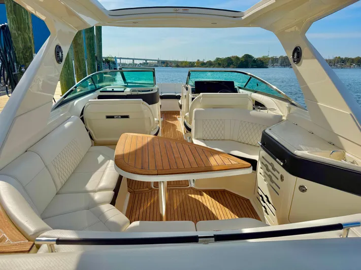  Yacht Photos Pics 2019 Sea Ray SLX 310 boat interior with luxurious seating and wooden table.