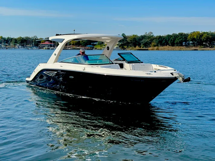  Yacht Photos Pics 2019 Sea Ray SLX 310 boat cruising on a calm lake under a clear blue sky.