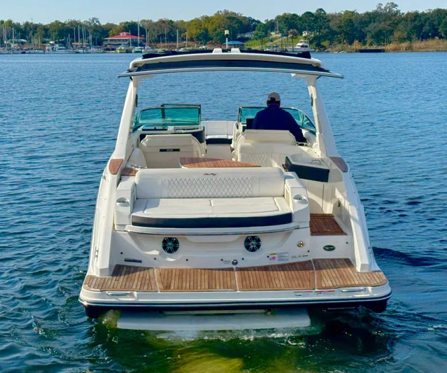  Yacht Photos Pics 2019 Sea Ray SLX 310 boat on water, rear view, with person at helm.