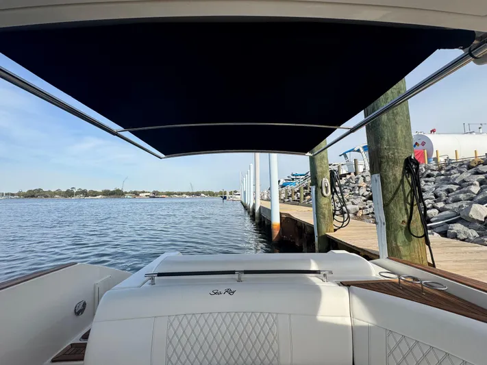  Yacht Photos Pics 2019 Sea Ray SLX 310 boat docked by a calm waterfront.