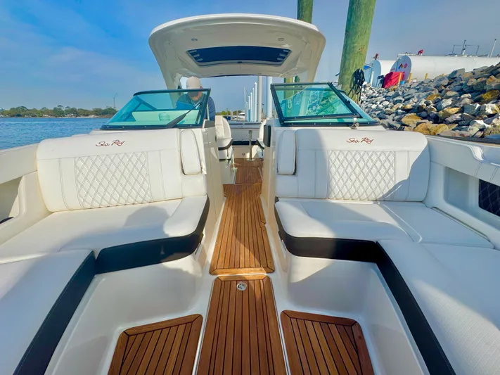  Yacht Photos Pics 2019 Sea Ray SLX 310 boat interior with white seating and wooden flooring.