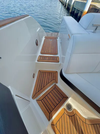  Yacht Photos Pics 2019 Sea Ray SLX 310 boat with teak deck, docked by the water.