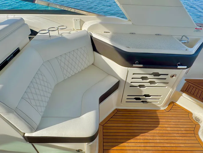  Yacht Photos Pics Luxurious 2019 Sea Ray SLX 310 boat interior with white seating and wooden flooring.