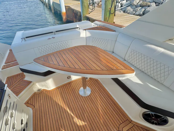  Yacht Photos Pics 2019 Sea Ray SLX 310 boat with teak deck and triangular table, docked by the water.