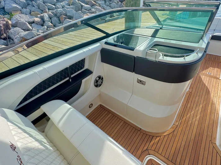  Yacht Photos Pics 2019 Sea Ray SLX 310 boat interior with teak flooring and cushioned seating.