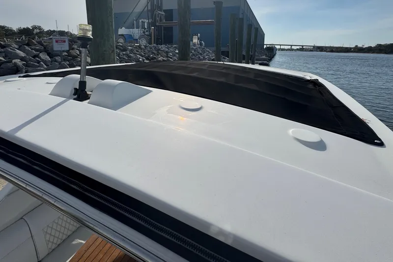  Yacht Photos Pics 2019 Sea Ray SLX 310 boat docked by the water, showcasing sleek design and spacious deck.