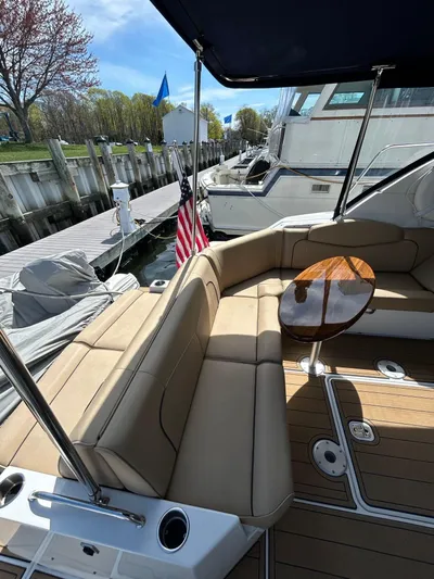  Yacht Photos Pics 2014 Cruisers Yachts 41 Cantius with beige seating and wooden table, docked at marina.