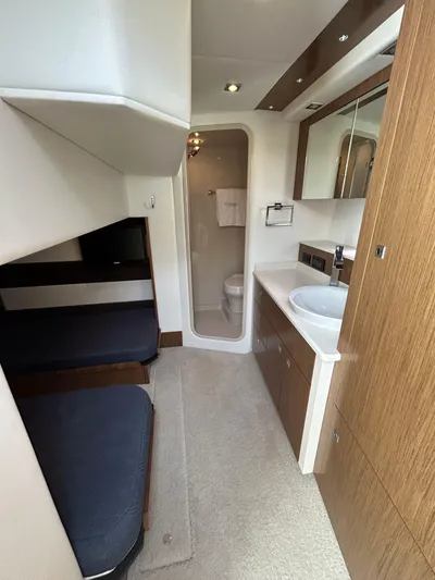  Yacht Photos Pics 2014 Cruisers Yachts 41 Cantius interior with modern bathroom and cozy sleeping area.