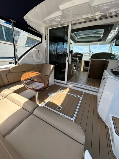  Yacht Photos Pics 2014 Cruisers Yachts 41 Cantius interior with tan seating and wooden accents.