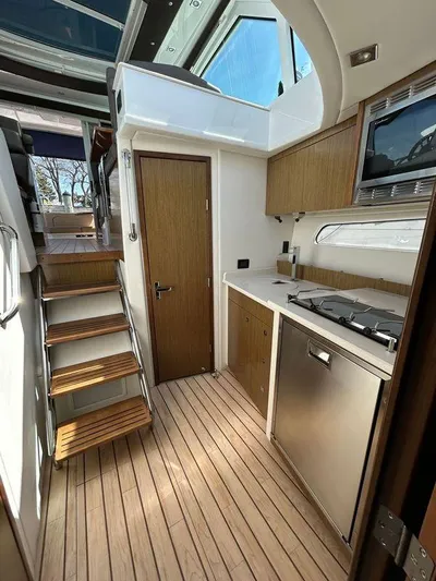  Yacht Photos Pics 2014 Cruisers Yachts 41 Cantius interior with modern kitchen and wooden flooring.