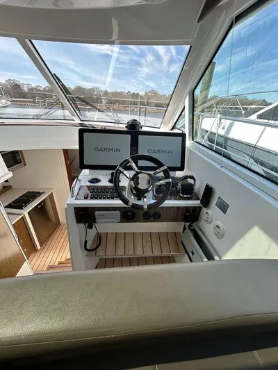  Yacht Photos Pics 2014 Cruisers Yachts 41 Cantius helm with Garmin navigation displays and steering wheel.