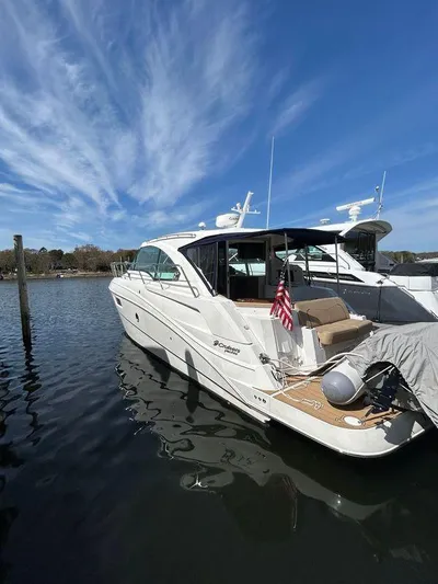  Yacht Photos Pics 2014 Cruisers Yachts 41 Cantius docked on calm water under a clear blue sky.