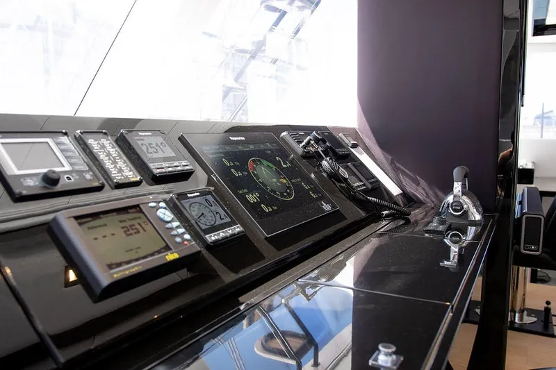  Yacht Photos Pics Control panel of a 2018 Sunreef 62 yacht, featuring navigation instruments and controls.