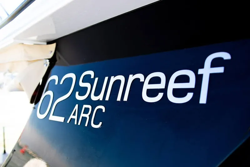  Yacht Photos Pics Close-up of 2018 Sunreef 62 ARC yacht branding on hull.
