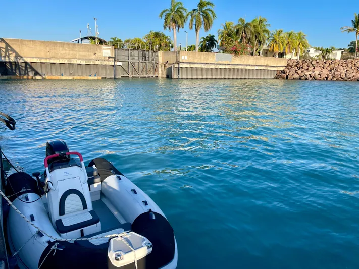  Yacht Photos Pics Inflatable boat on calm water near a dock with palm trees, Sunreef 62, 2018.