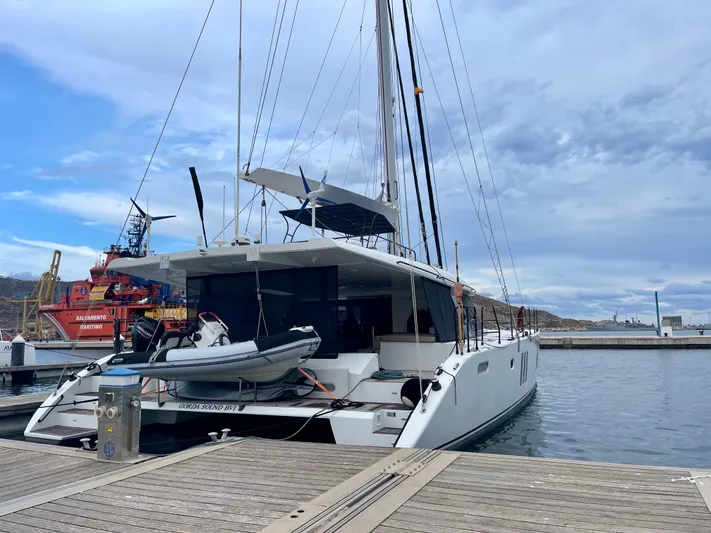  Yacht Photos Pics 2018 Sunreef 62 catamaran docked at marina, featuring sleek design and modern amenities.
