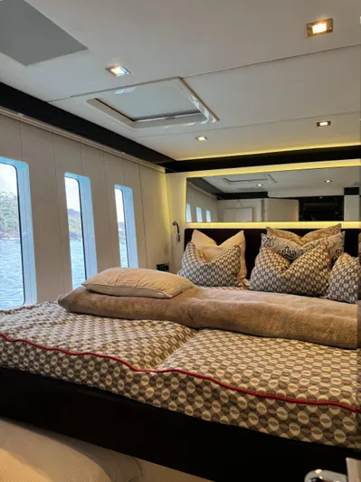  Yacht Photos Pics Luxurious bedroom interior of 2018 Sunreef 62 yacht with plush bedding and large windows.