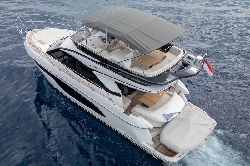  Yacht Photos Pics 2024 Princess F45 yacht cruising on open water, featuring sleek design and spacious deck.
