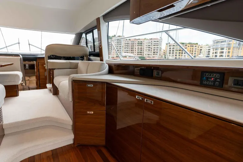  Yacht Photos Pics Luxurious interior of 2024 Princess F45 yacht with elegant wood finishes and plush seating.