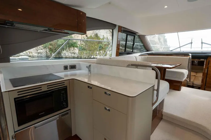  Yacht Photos Pics Luxurious interior of 2024 Princess F45 yacht featuring modern kitchen and dining area.