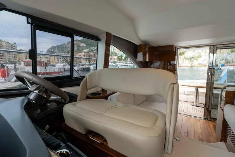  Yacht Photos Pics Interior of 2024 Princess F45 yacht, featuring luxurious seating and scenic marina view.