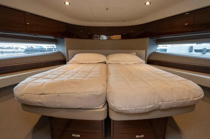  Yacht Photos Pics Luxurious 2024 Princess F45 yacht bedroom with twin beds and elegant wood finish.
