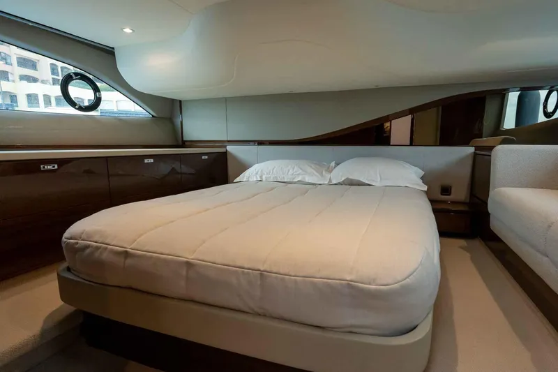  Yacht Photos Pics Luxurious bedroom interior of 2024 Princess F45 yacht with elegant design and cozy bedding.