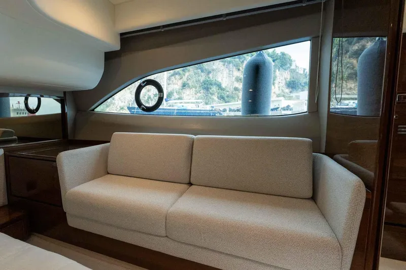  Yacht Photos Pics Luxurious interior of 2024 Princess F45 yacht with elegant sofa and scenic window view.