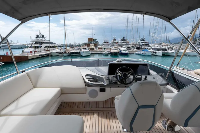  Yacht Photos Pics Luxurious 2024 Princess F45 yacht interior with marina view, featuring elegant seating and modern controls.