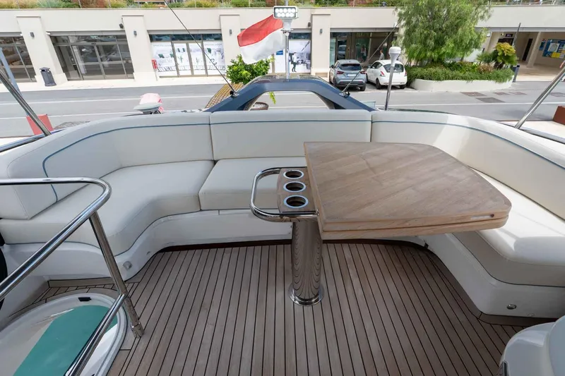  Yacht Photos Pics Luxurious 2024 Princess F45 yacht deck with elegant seating and wooden table.