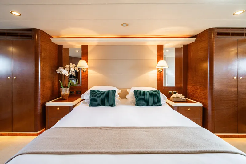 Viking III Yacht Photos Pics Luxurious bedroom interior on 2004 Notika CENTURION 115 yacht, featuring elegant wood finishes.