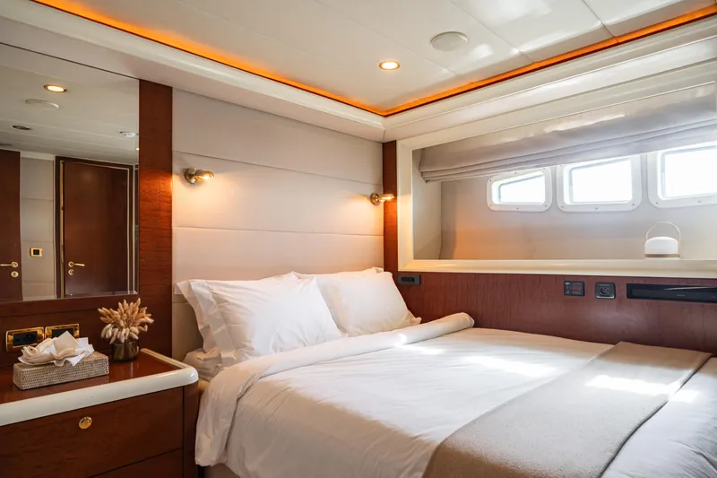 Viking III Yacht Photos Pics Luxurious bedroom interior on 2004 Notika CENTURION 115 yacht, featuring elegant wood accents.
