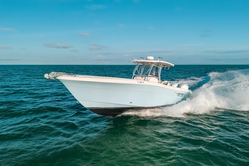  Yacht Photos Pics 2005 Hydra-Sports 3300 CC boat cruising on open ocean under clear blue sky.