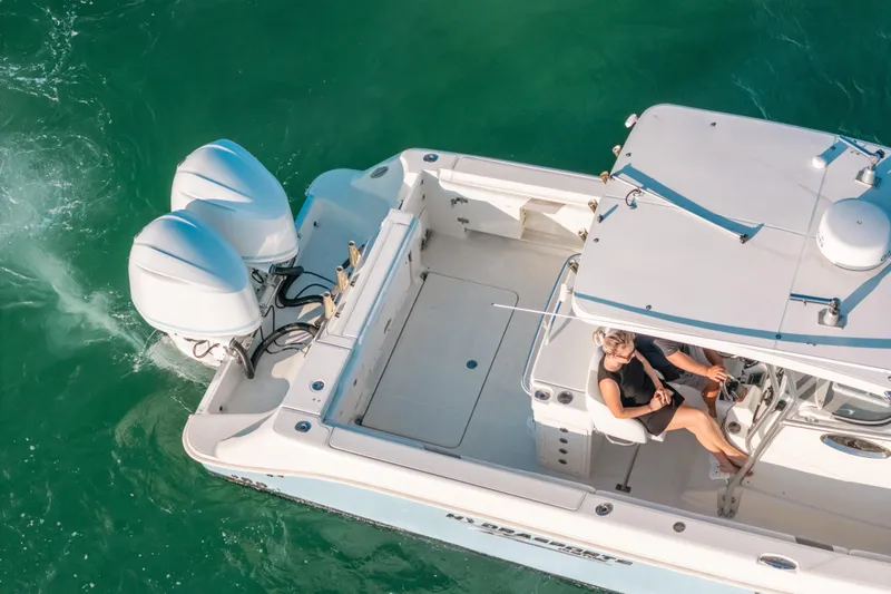  Yacht Photos Pics Aerial view of 2005 Hydra-Sports 3300 CC boat cruising on turquoise water.