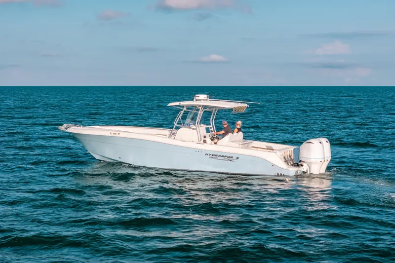  Yacht Photos Pics 2005 Hydra-Sports 3300 CC boat cruising on open ocean waters.