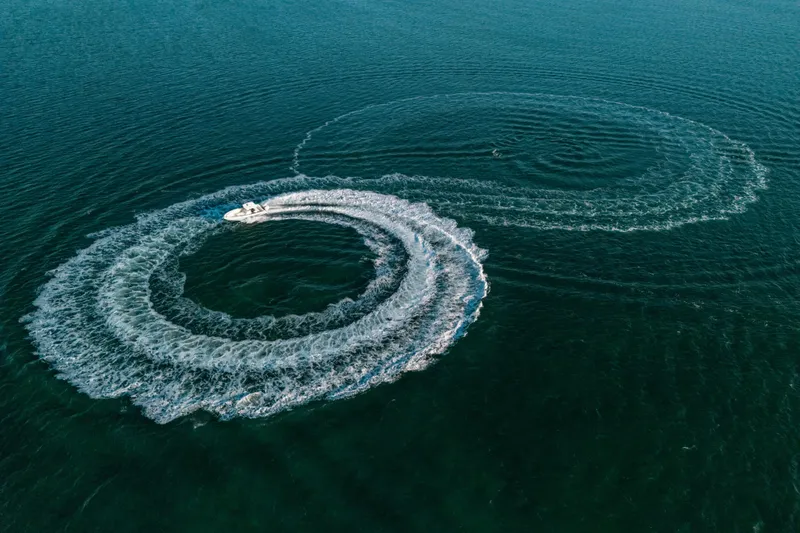  Yacht Photos Pics Aerial view of 2005 Hydra-Sports 3300 CC creating circular wake patterns in the ocean.
