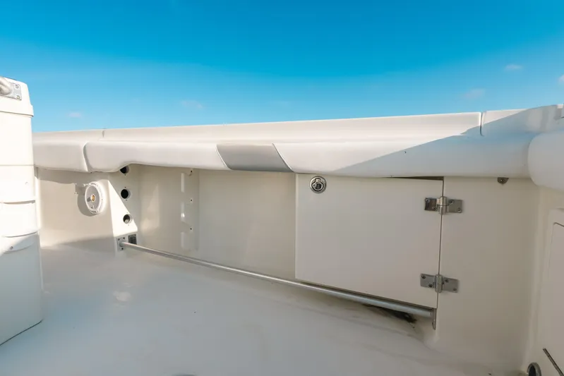  Yacht Photos Pics 2005 Hydra-Sports 3300 CC boat interior with storage compartment and speaker, under clear blue sky.