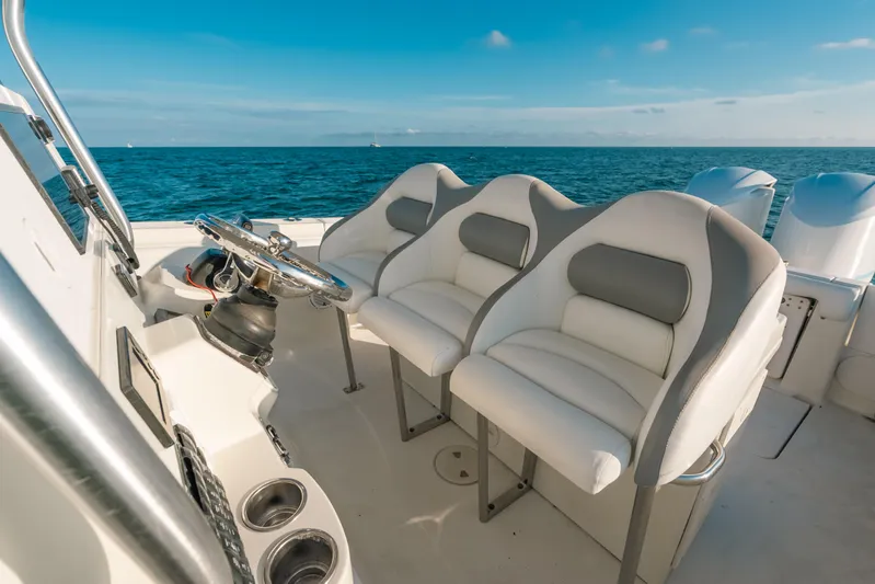  Yacht Photos Pics 2005 Hydra-Sports 3300 CC boat interior with steering wheel and cushioned seats on open water.