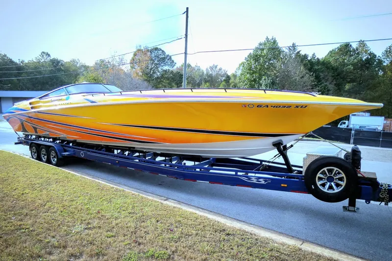  Yacht Photos Pics 2006 Fountain 47 Lightning speedboat on trailer, vibrant yellow and orange design.