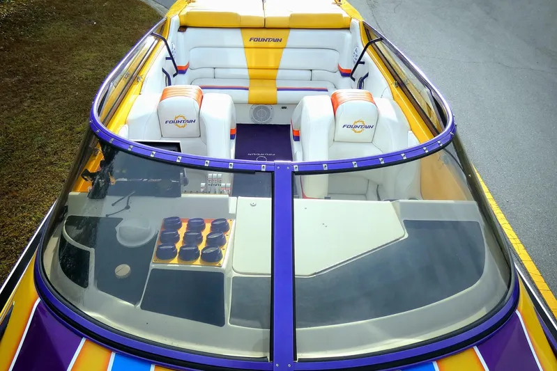  Yacht Photos Pics 2006 Fountain 47 Lightning boat interior with vibrant seating and dashboard view.