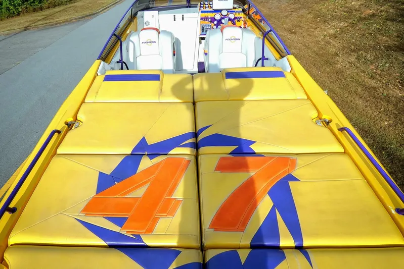  Yacht Photos Pics 2006 Fountain 47 Lightning boat with vibrant yellow and blue design, featuring bold "47" graphics.