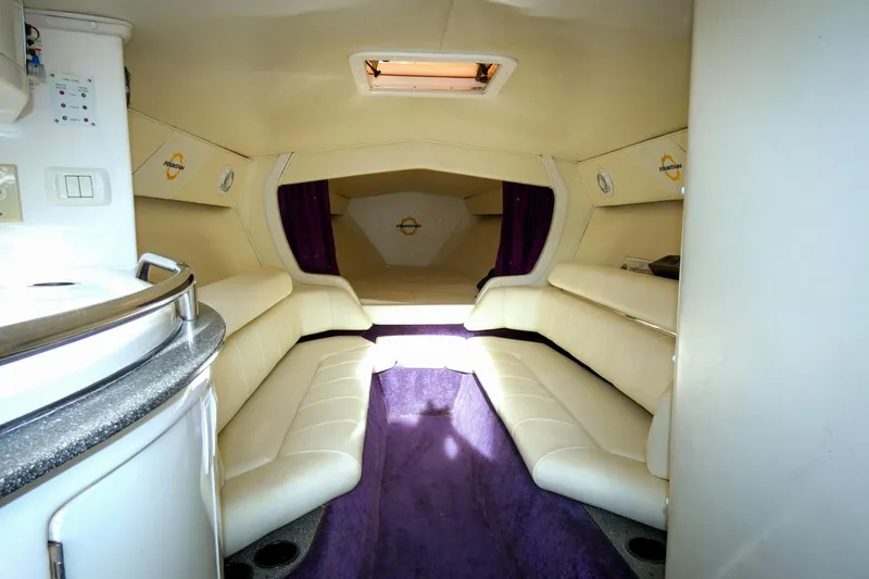  Yacht Photos Pics Interior of 2006 Fountain 47 Lightning boat with white seating and purple accents.
